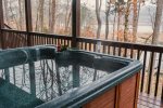 Relax in the lakefront deck hot tub at Ma Cook Lodge